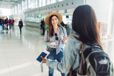 120293623 female tourists with bags in international airport